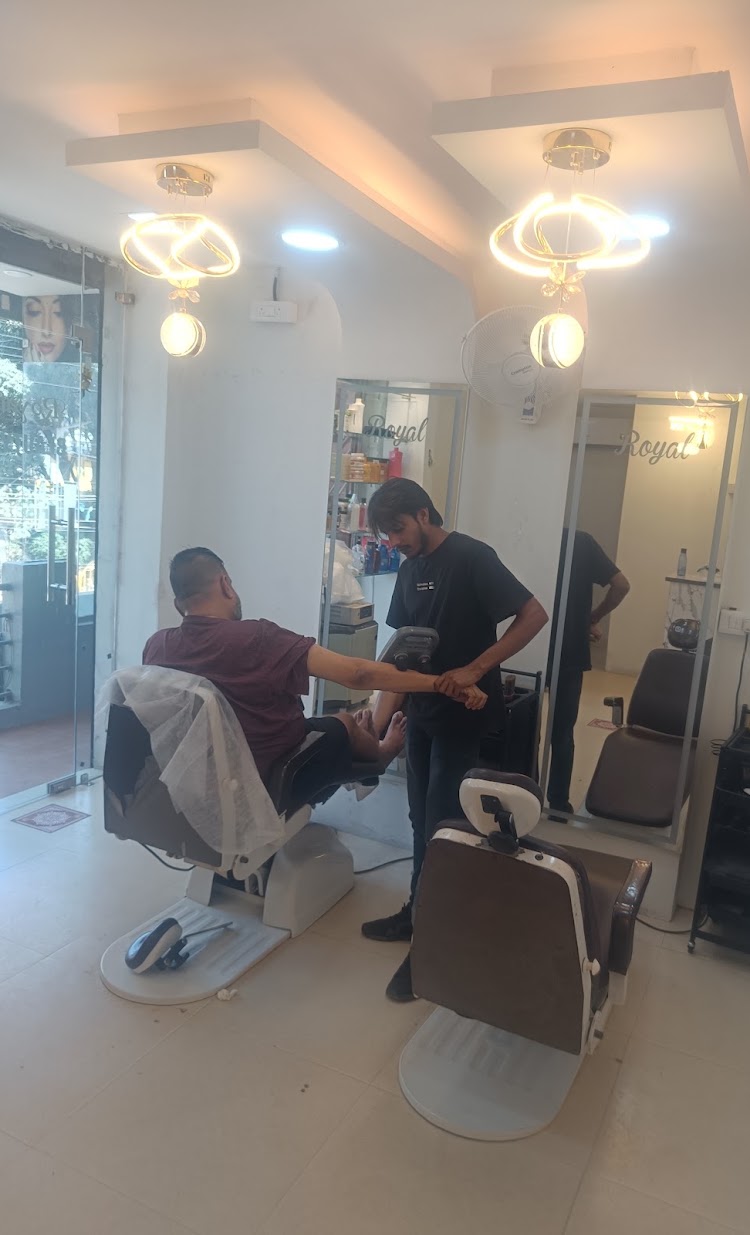 A barber working with a client inside the salon